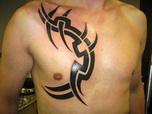 chest lettering tattoos for men. Tribal for men.