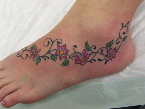 flower lower back tattoos. mystical black and girl-